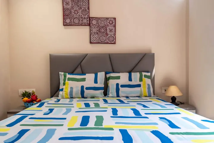Bedroom with queen bed and balcony light