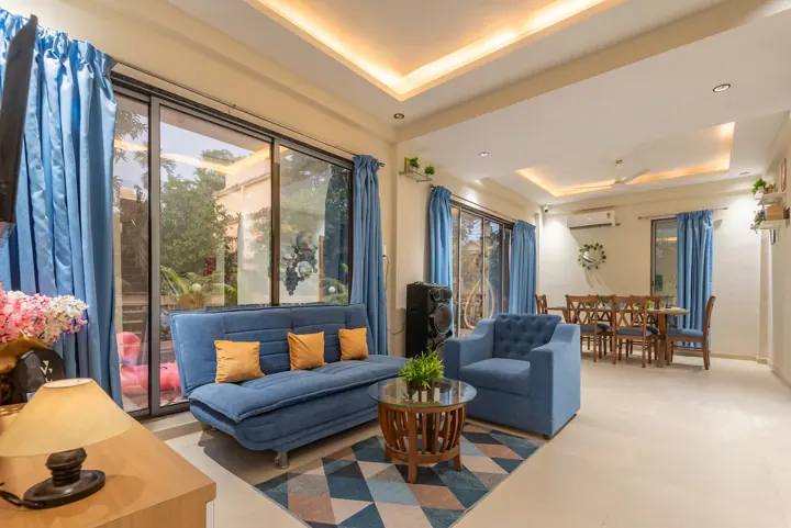 Villa living and dining area with garden views near Mumbai