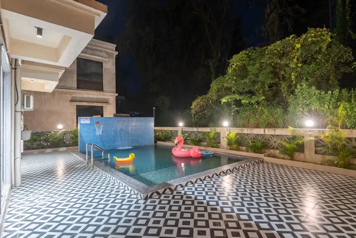 Private pool and terrace lit up at night