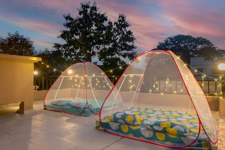 Rooftop terrace with tents under fairy lights